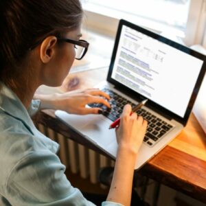 Woman on laptop getting virtual online learning.